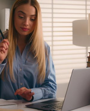 Caucasian student happy smiling girl woman studying with laptop and books homework learning online knowledge prepare for test exam study at library cram SAT test bookworm research history prep course