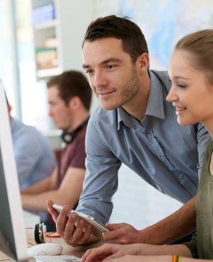 Student girl with trainer working on computer and tablet